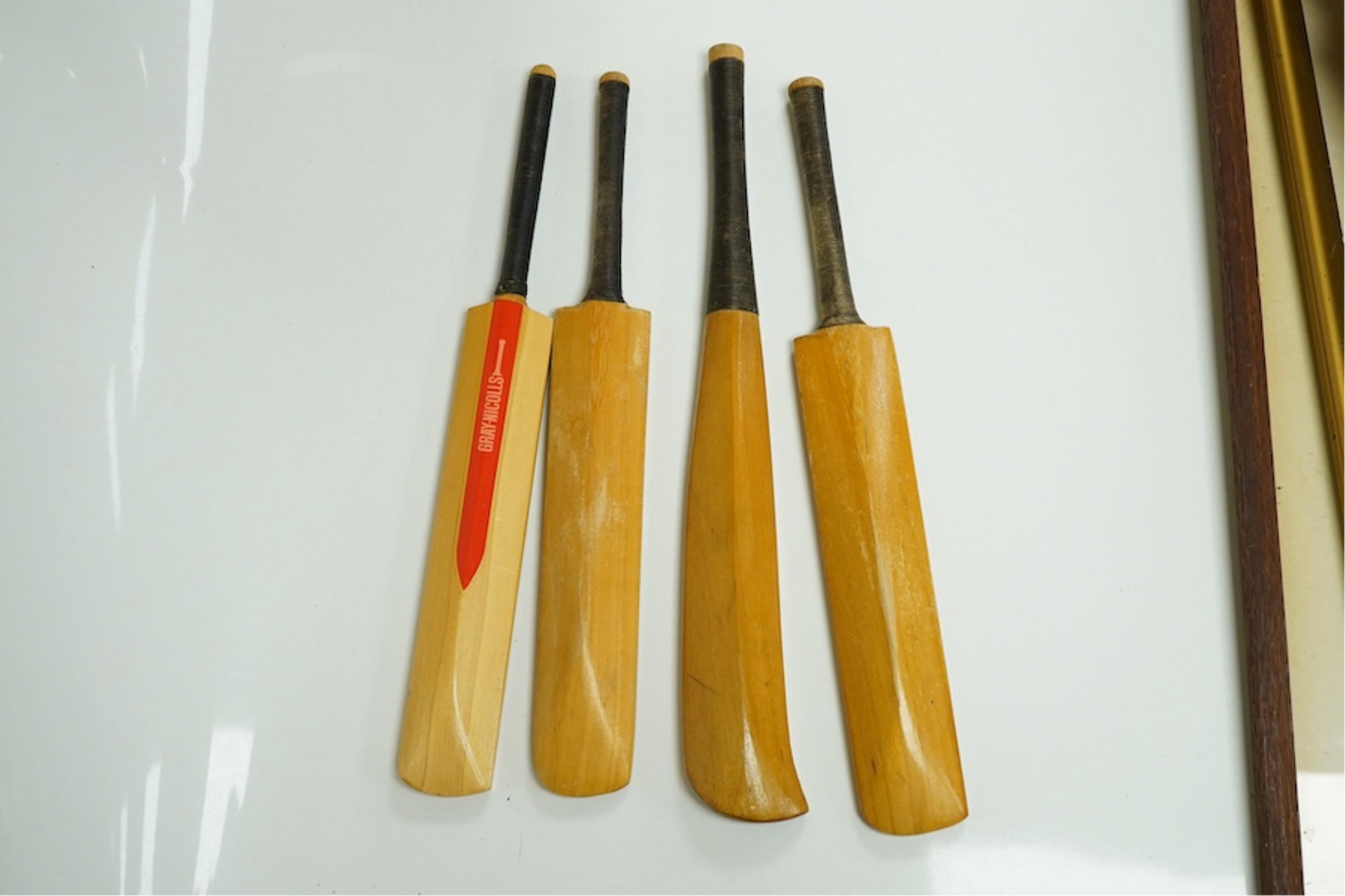 Four miniature model cricket bats, one signed, others printed. Condition - fair to good